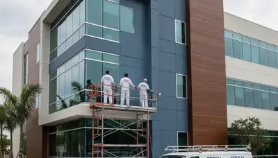 Professional commercial painters working on an office building exterior in Detroit, MI